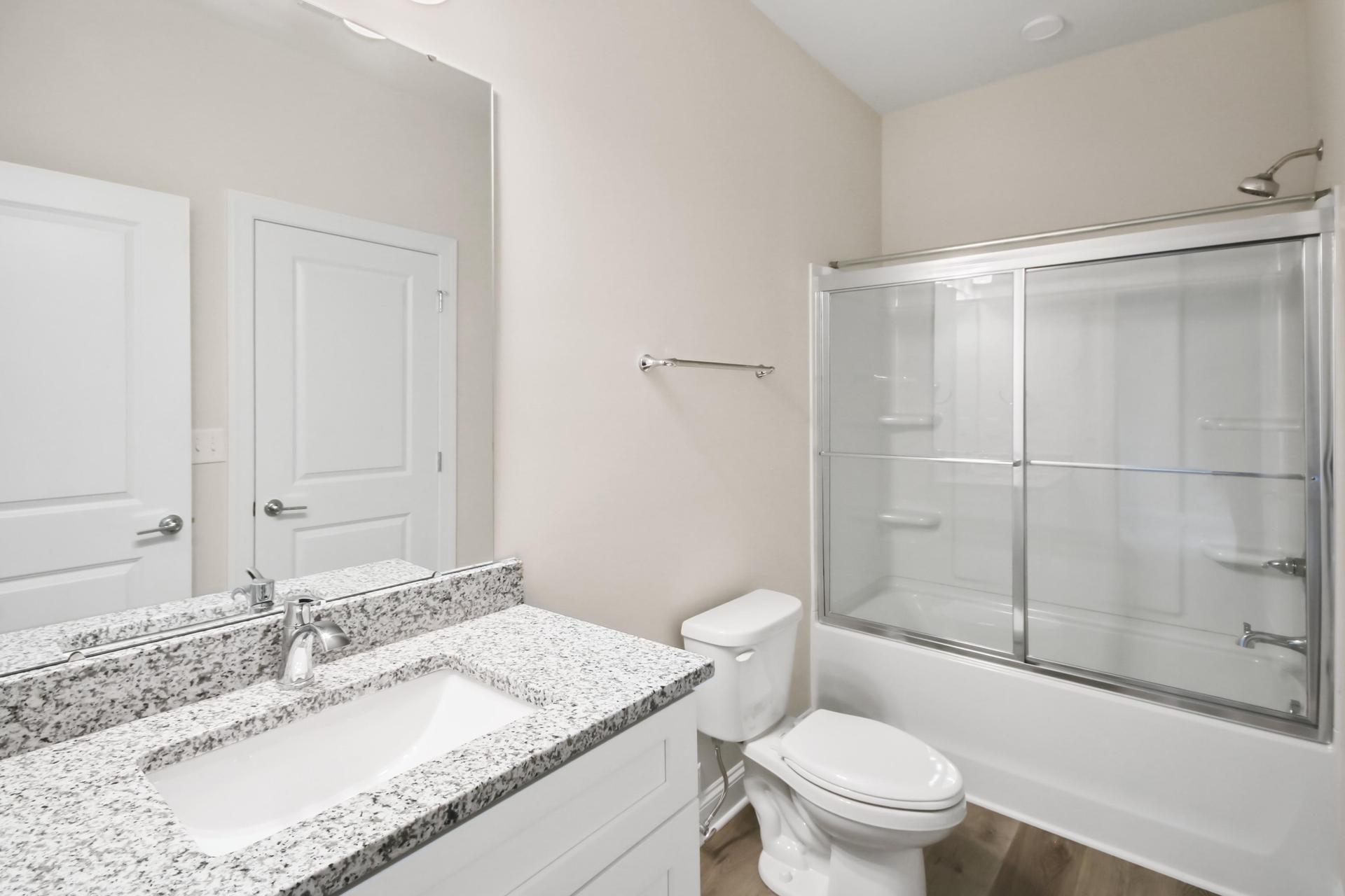 Dumphries Dr modern bathroom with glass shower and premium fixtures