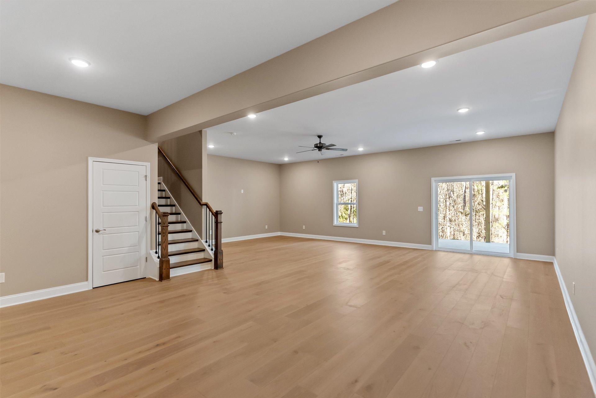 Green Meadows open concept living space with balcony access