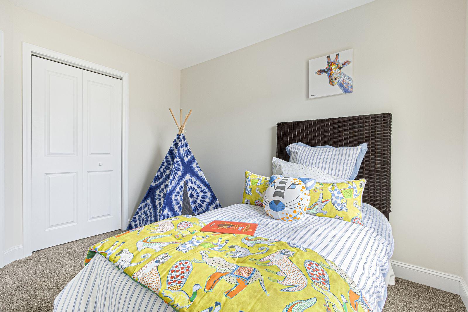 Snowmass guest bedroom with natural light and ceiling fan