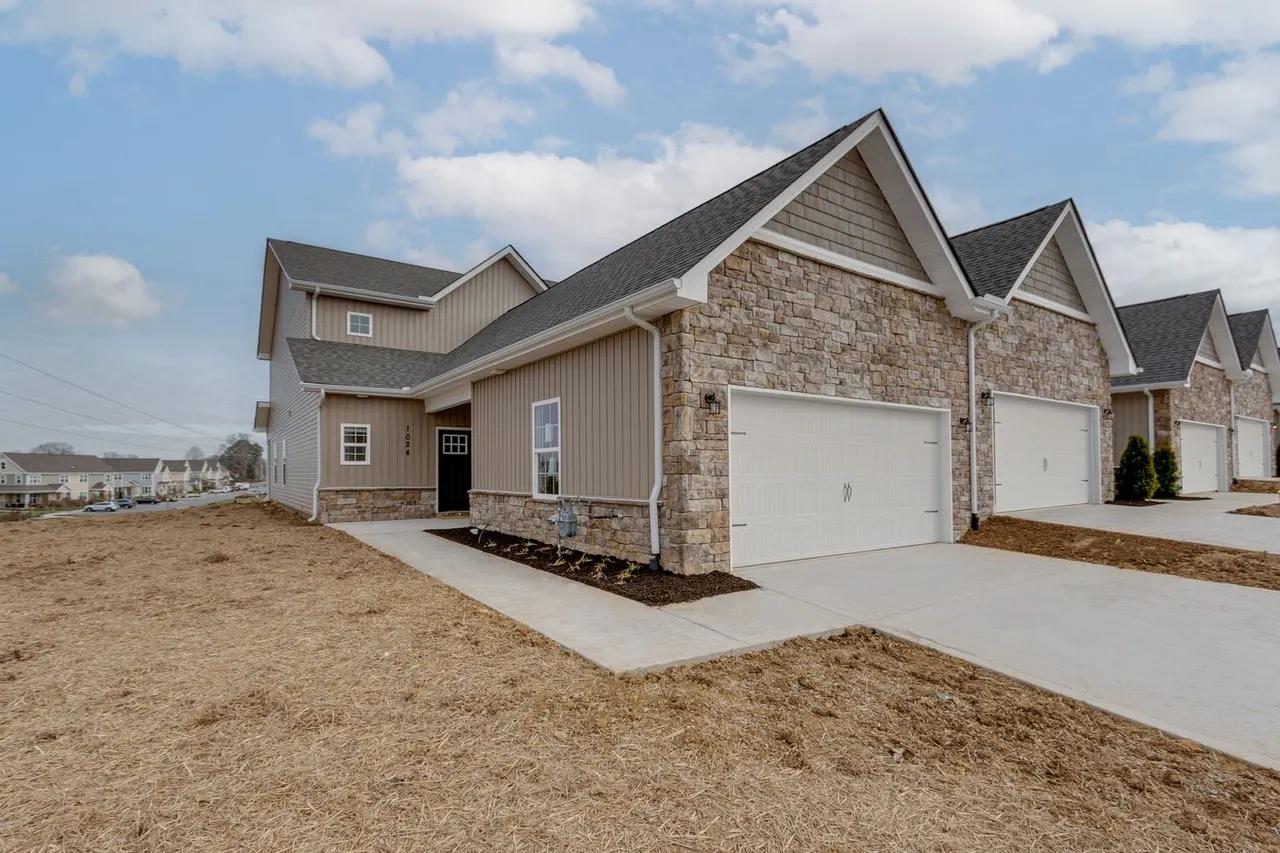 Row of new-construction rental townhomes with stone-veneer exteriors and attached two-car garages at Preston Park in Maryville, Tennessee - one of the five best rental communities in the Greater Knoxville area featured in this guide