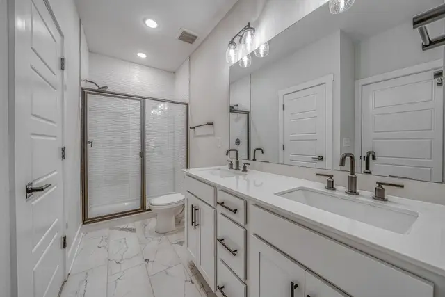 Allston modern bathroom with glass shower and premium fixtures