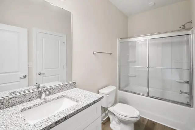 Dumphries Dr modern bathroom with glass shower and premium fixtures