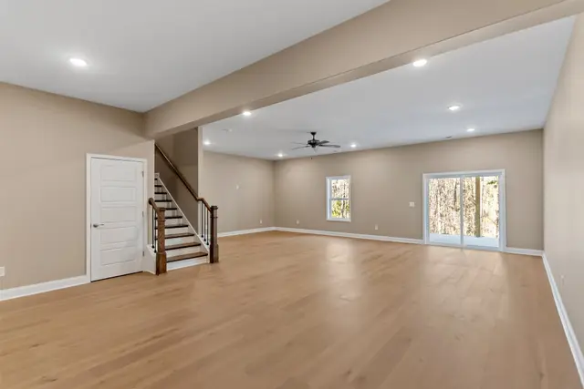 Green Meadows open concept living space with balcony access
