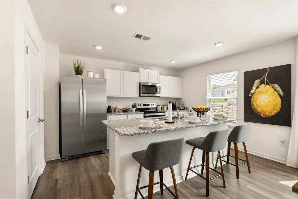 Mockingbird Meadows modern kitchen with island, white cabinets, pendant lights, and premium finishes