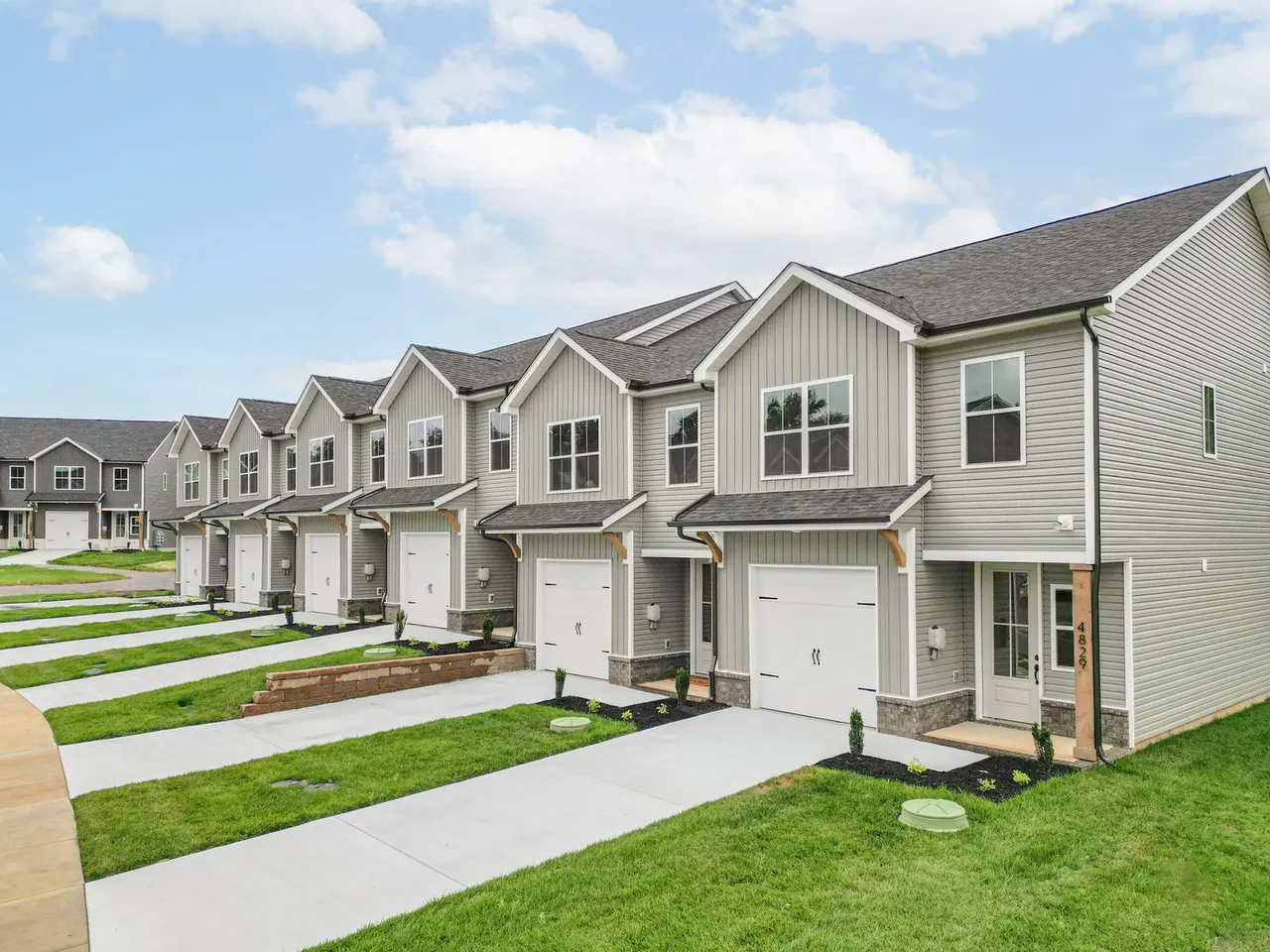 Row of new-construction Snowmass townhomes with attached garages in Halls, North Knoxville, the rental home used in this rent vs buy comparison